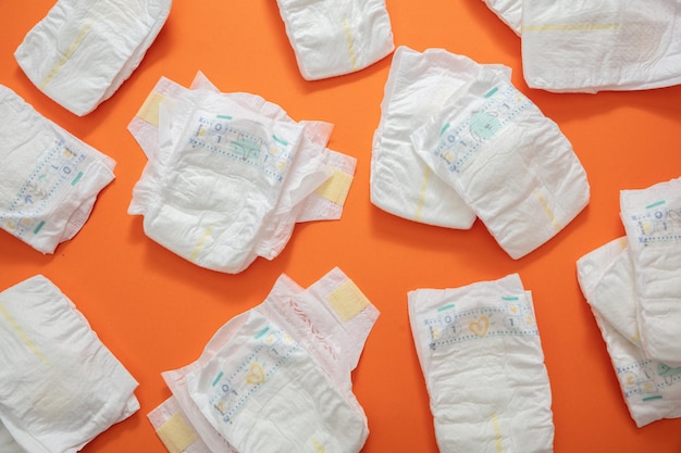 Photo baby diapers collection on orange color background