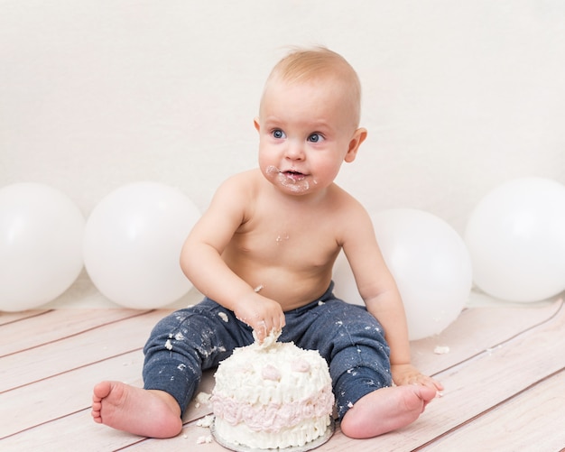 Baby eating birthday cake