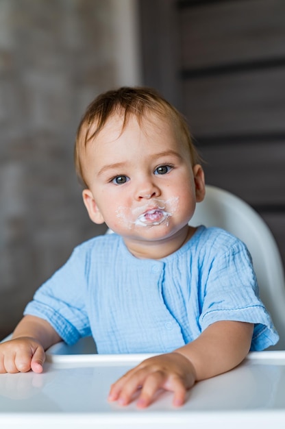 Baby eating food on kitchen Feeding baby food to baby