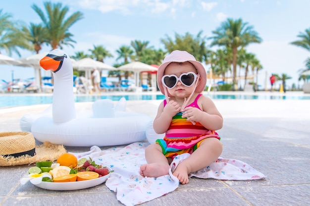 Baby eats fruit on vacation. Food.