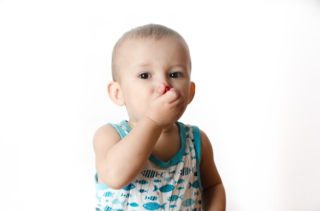 Baby eats a pomegranate, ripe and juicy, very tasty and joyfully