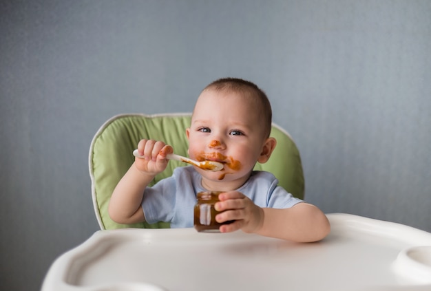 Baby eats with a spoon