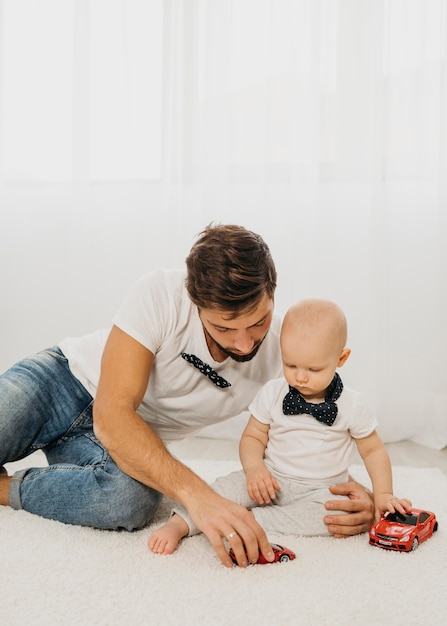 Photo baby and father playing together at home