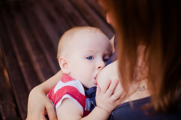 Baby feeds on MOM's breasts