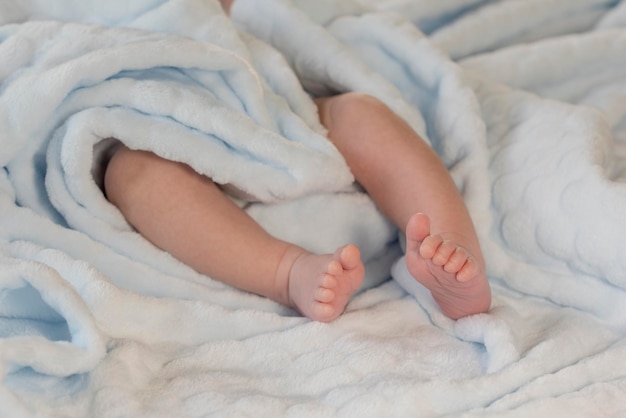 Baby feet on blue coverlet