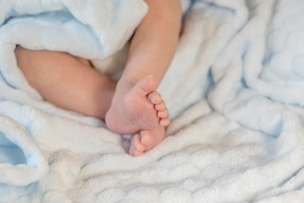 Baby feet on blue coverlet