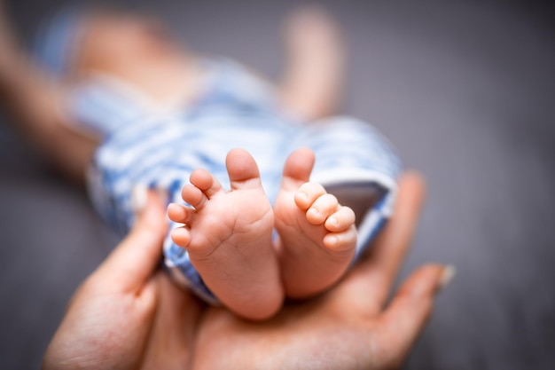 Baby feet in mother arm Newborn baby feet