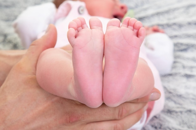 Baby feet in mother hands in Happy family maternity concept