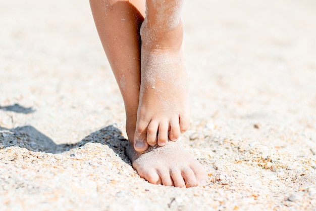 baby feet in the sand in summer