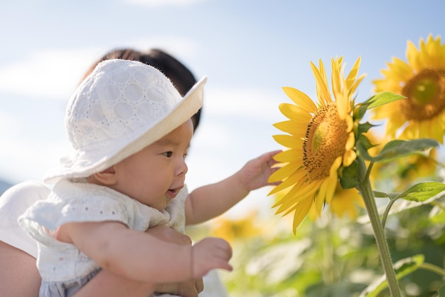 A baby in a field of sunflowers