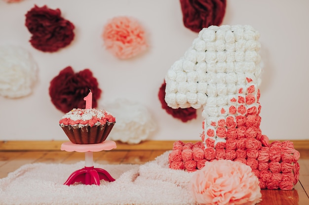 Baby first birthday party. Focus on cake with candle