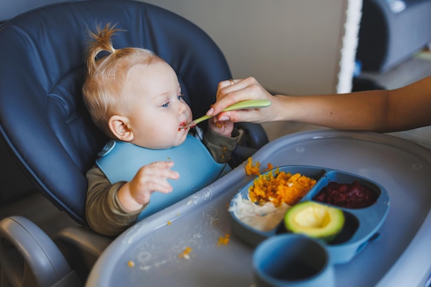 Photo baby food for 6 months the boy eats mashed food child development