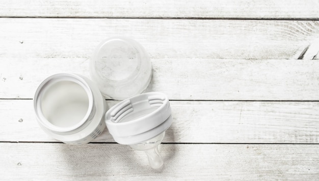 Baby food Baby milk in small bottle on a white wooden table