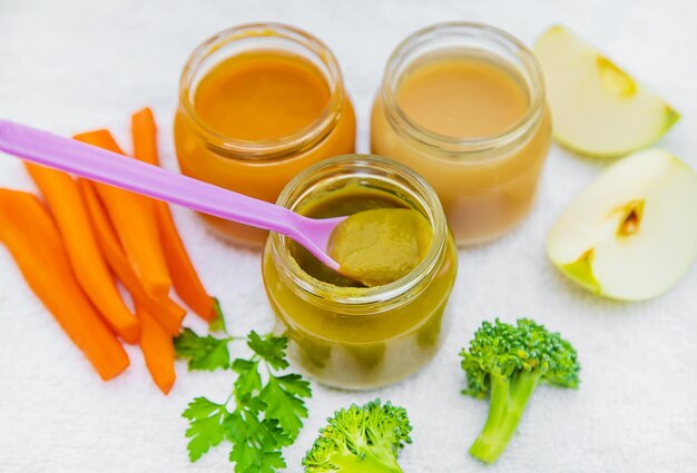 Baby food mashed vegetables and fruits in jars selective focus