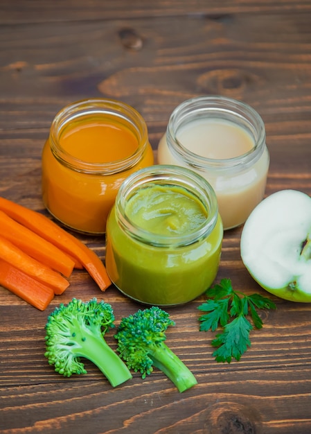 Baby food. Mashed vegetables and fruits in jars. Selective focus.