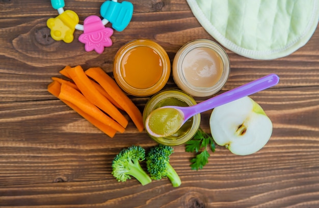 Baby food. Mashed vegetables and fruits in jars. Selective focus.