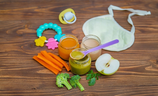 Baby food. Mashed vegetables and fruits in jars. Selective focus.