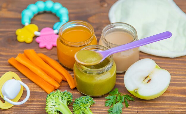 Baby food. Mashed vegetables and fruits in jars. Selective focus.