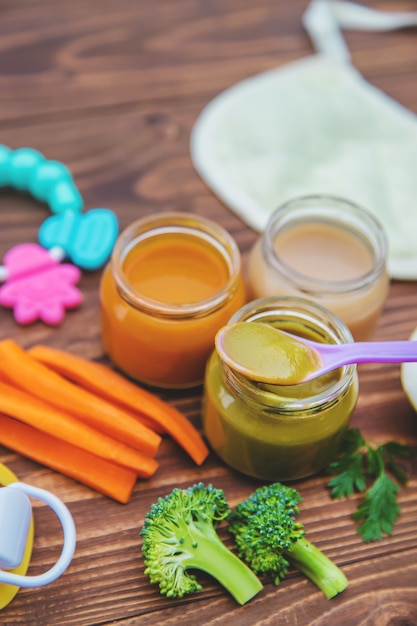 Baby food. Mashed vegetables and fruits in jars. Selective focus.