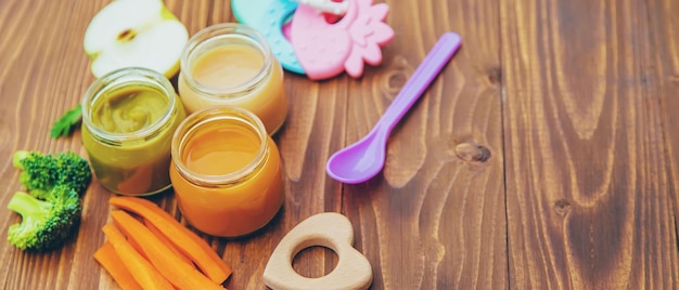 Baby food Mashed vegetables and fruits in jars Selective focus