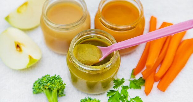 Baby food. Mashed vegetables and fruits in jars. Selective focus.