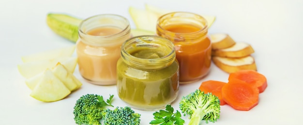 Baby food in small jars. Selective focus.