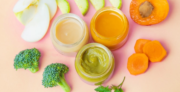 Baby food in small jars. Selective focus.