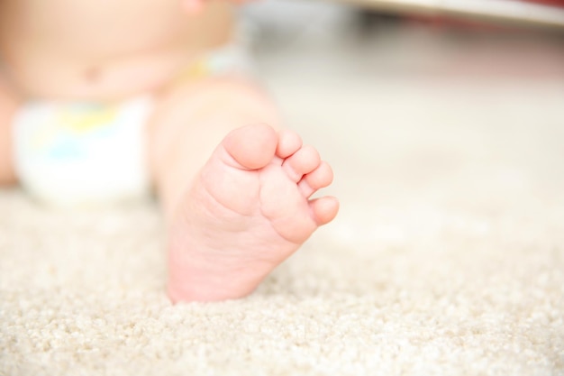 Baby foot on a carpet close up