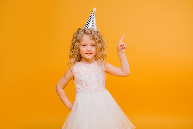 baby girl birthday smiling on orange