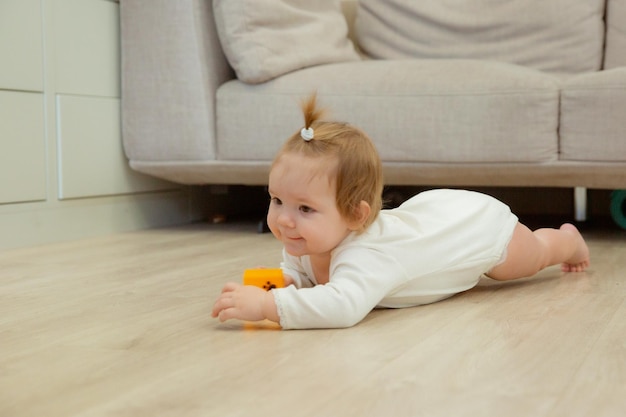 Baby girl crawling on the floor at home