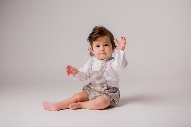 Bambina bruna riccia 6 mesi su bianco