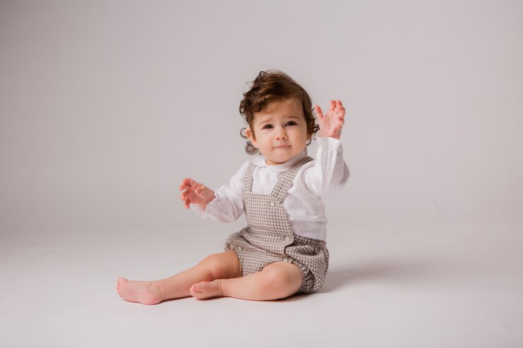 Photo baby girl curly brunette 6 months on white