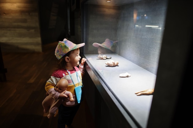 Baby girl exploring expositions in museum halls