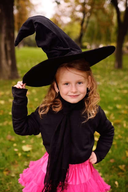 Baby girl in a Halloween costume and a witch's hat