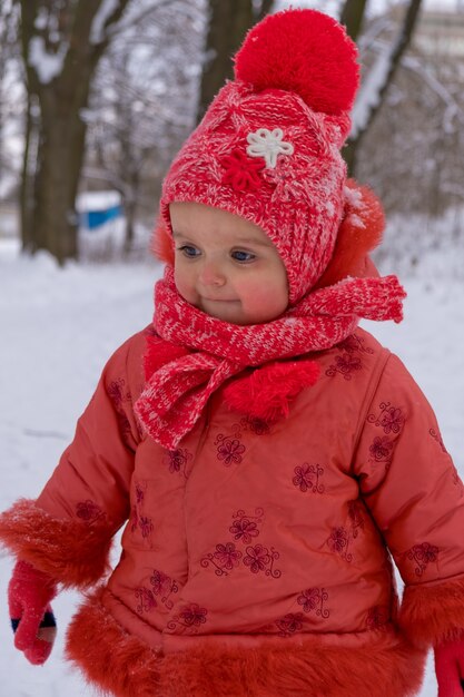 Baby girl impressed with the snow. Close-up.