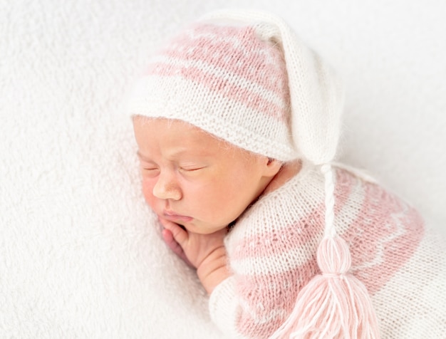 Baby girl in knitted suit and hat