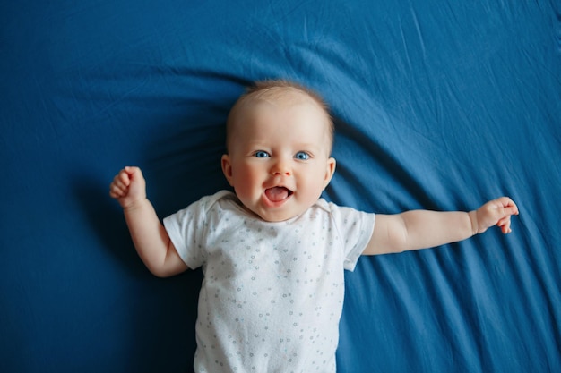 baby girl lying on bed at home
