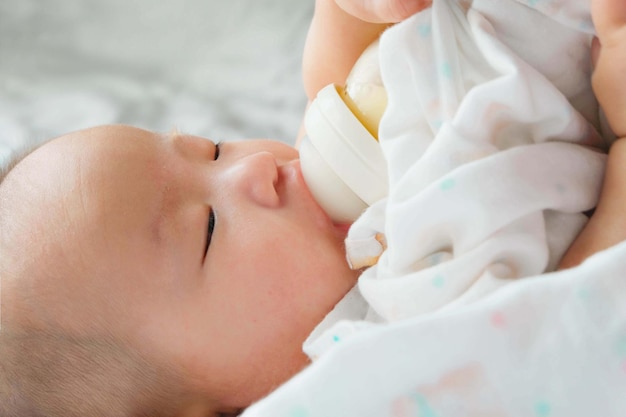 Baby girl lying on bed