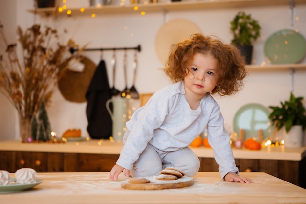 Baby girl in pajamas in the kitchen