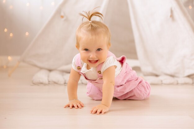 Baby girl playing in the nursery