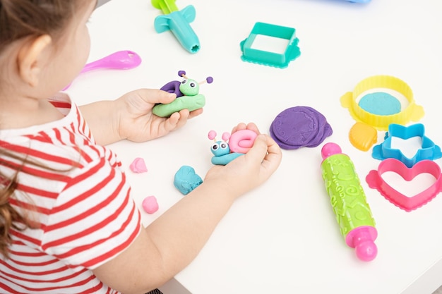 Plasticine Modeling Clay In Children Class. Teacher Teaches Kids Together  Play Dough And Mold From Plasticine In Kindergarten Or Preschool. Group Of  Four People. Zoo From The Clay. Stock Photo, Picture and