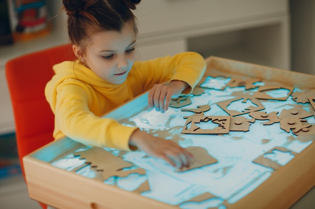 Baby girl playing with sand form toy Early age education Toddler cognitive psychology concept