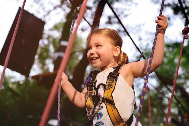 Baby girl on a rope park background