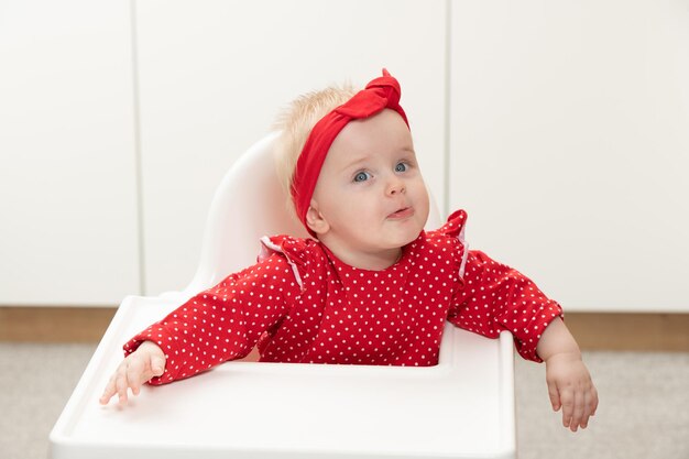 Baby Girl Sitting on Chair Waiting for Meal