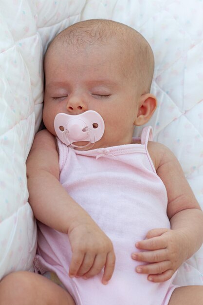 Baby girl sleeping in a pink blanket