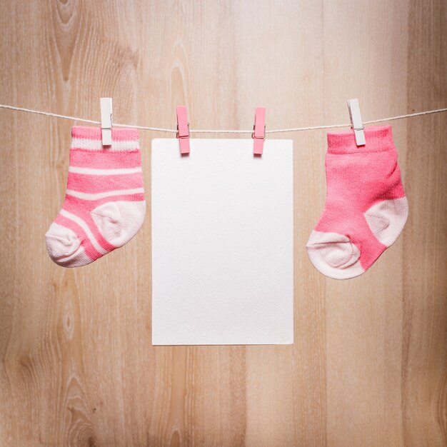 Baby girl socks attached to the rope and blank card