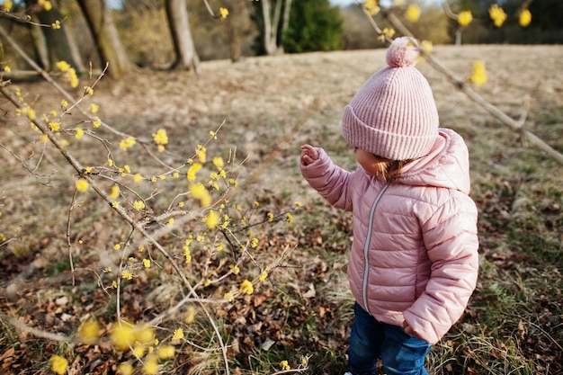 Baby girl wear pink jacket walking at Valtice park Czech Republic