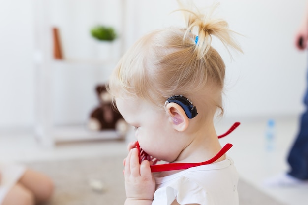 Baby girl wearing a hearing aid. 