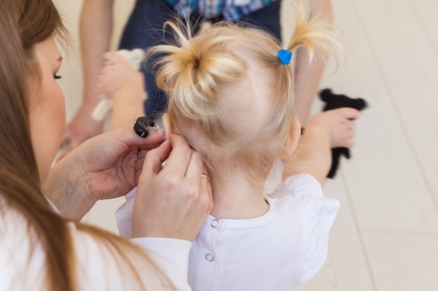 Baby girl wearing a hearing aid. 