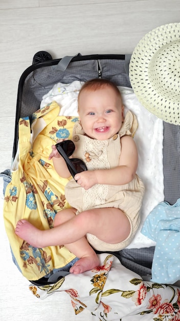 Baby girl with excited expression prepares for vacation